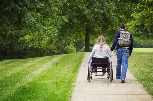 Couple holding hands in park