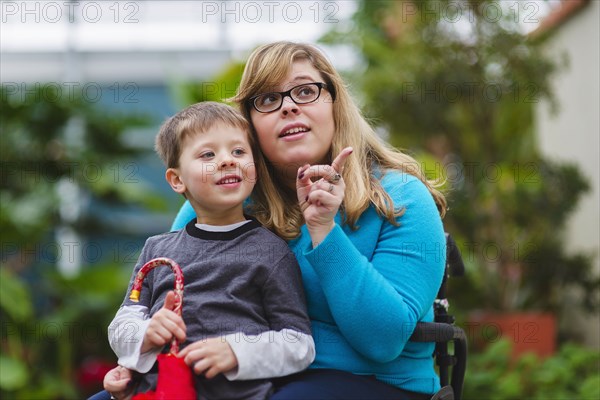 Paraplegic mother and son exploring outdoors