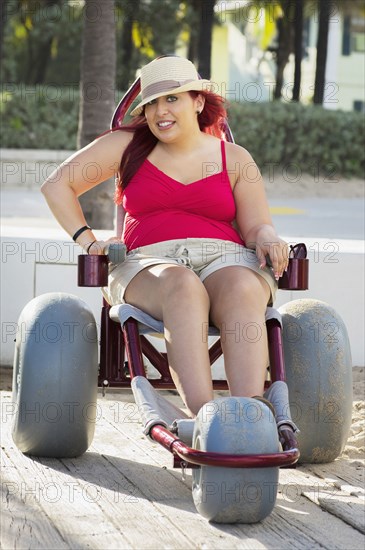 Paraplegic woman in wheelchair on walkway