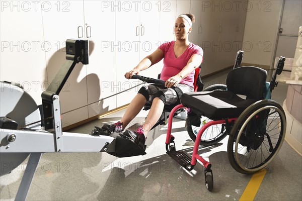 Paraplegic woman working out in physical therapy