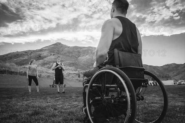 Paraplegic athlete in wheelchair playing on field