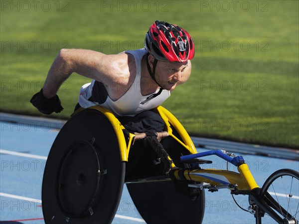 Man racing in wheelchair on track