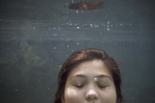 Mixed race teenager underwater
