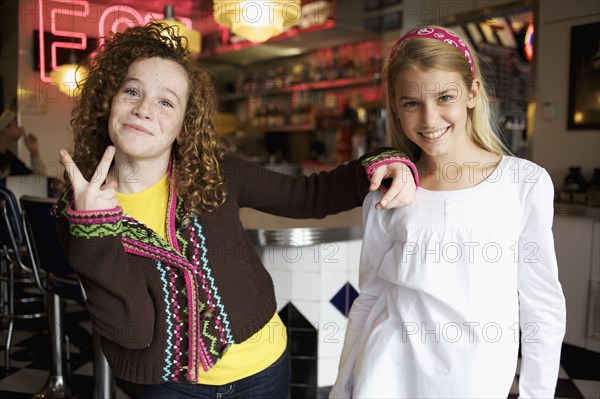 Playful Caucasian girls in cafe