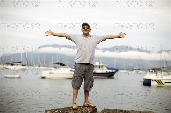 Hispanic man standing at waterfront