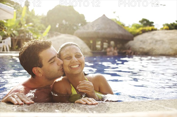 Couple hugging in swimming pool