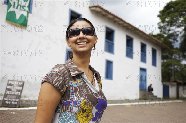 Smiling mixed race woman wearing sunglasses