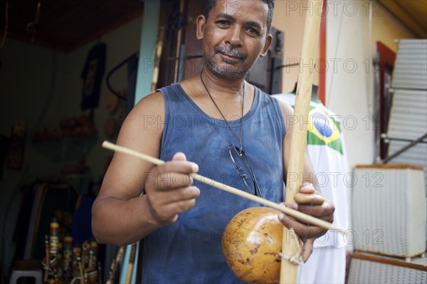 Mixed race man standing with musical instrument