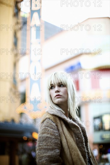 Caucasian woman standing outdoors in fur coat