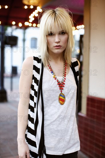 Caucasian woman standing in fashionable clothing