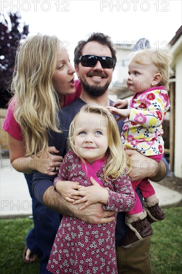 Caucasian family standing in backyard