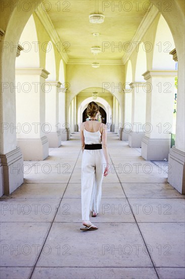 Caucasian woman walking in portico