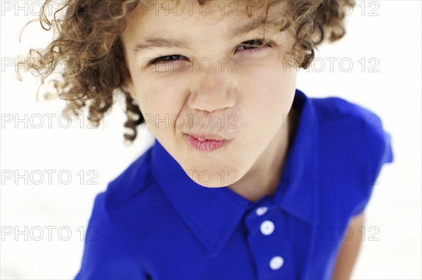 Mixed race boy grimacing