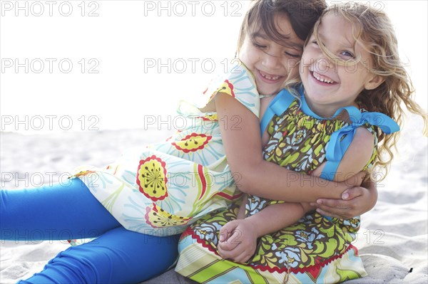 Children hugging on beach