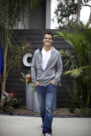 Smiling Caucasian man walking outdoors