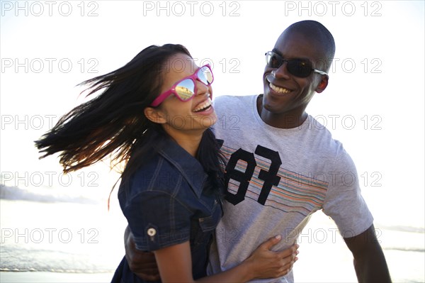 Laughing couple enjoying beach