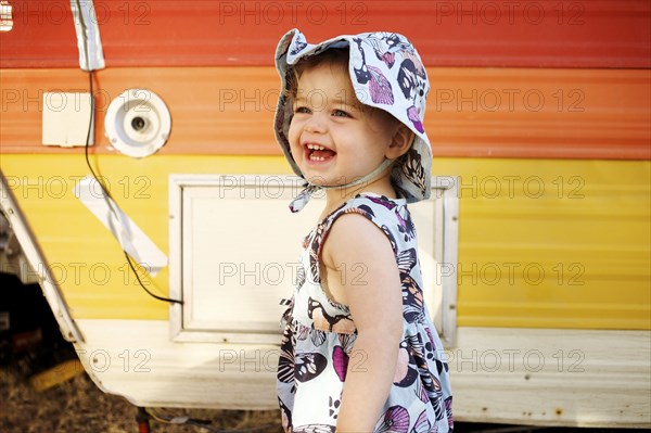 Laughing Caucasian girl near camper