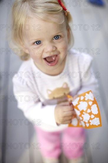 Caucasian girl playing with stickers