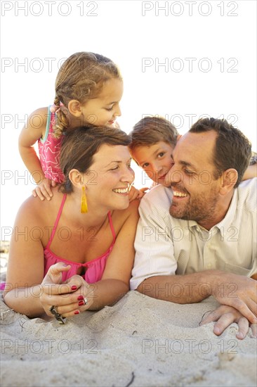 Family laying on beach together