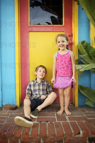 Brother and sister sitting on front stoop