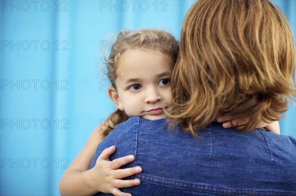 Mother holding and comforting daughter