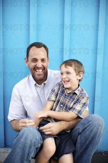 Father holding son on lap