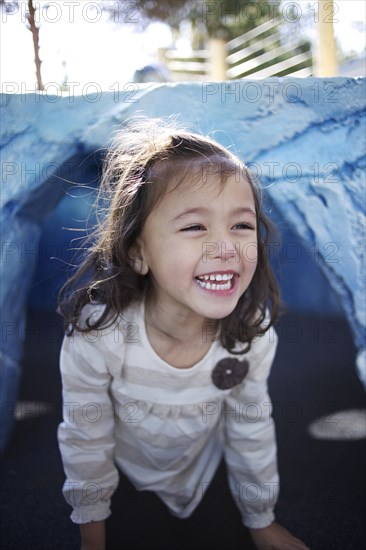 Grinning mixed race girl crawling