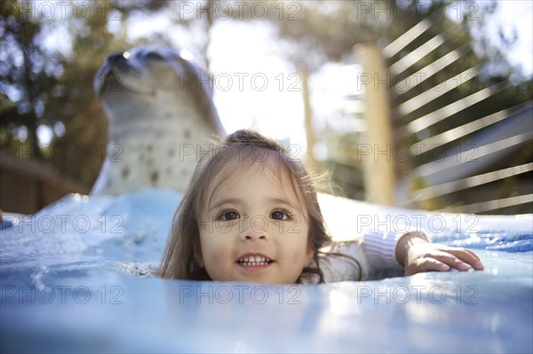 Mixed race girl playing at zoo