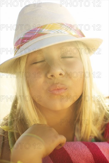 Mixed race girl making kissing motion