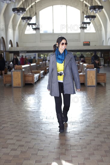 Mixed race woman walking in historic building