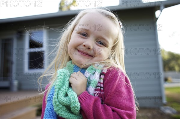 Grinning Caucasian girl wearing scarf