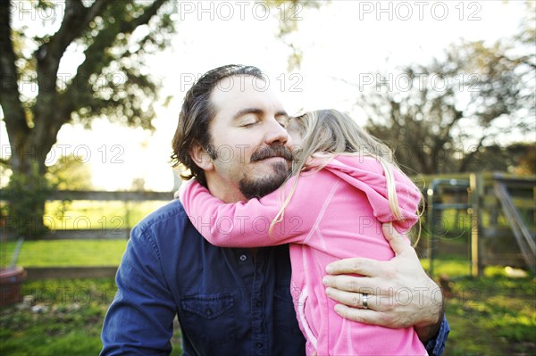Father hugging daughter