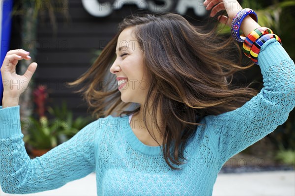 Mixed race woman dancing outdoors