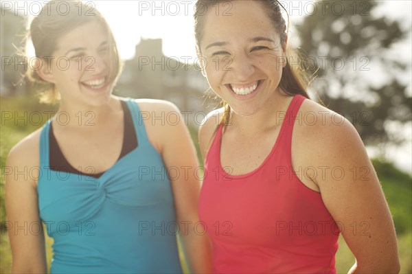 Athletic women smiling together outdoors