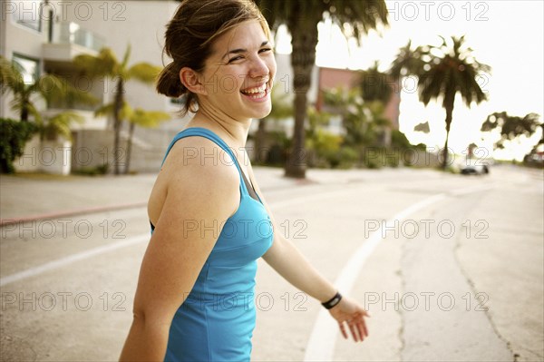 Athletic mixed race woman crossing street