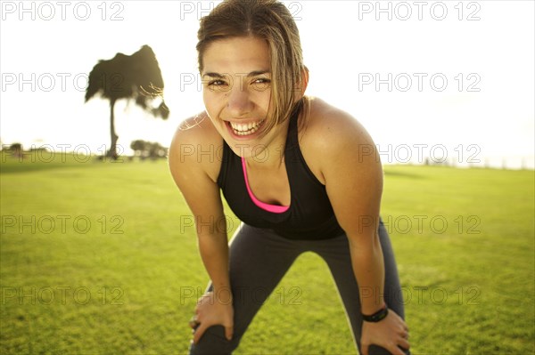 Mixed race woman standing in field after exercise