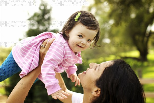 Mother holding toddler daughter