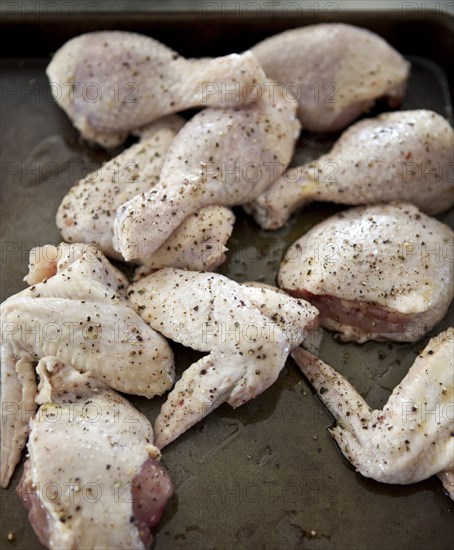 Close up of seasoned raw chicken pieces