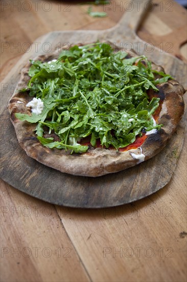 Arugula lettuce topping on pizza