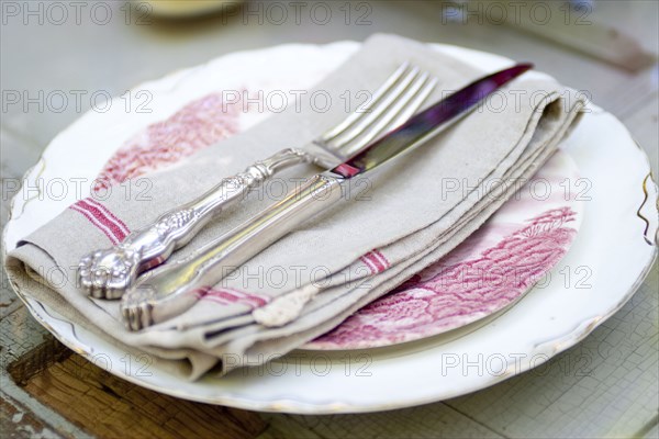 Silverware and napkin on plate