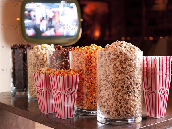 Various flavors of popcorn in containers