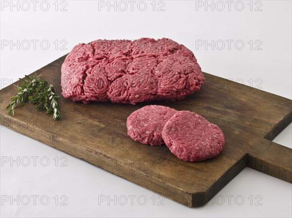 Raw hamburger meat on cutting board