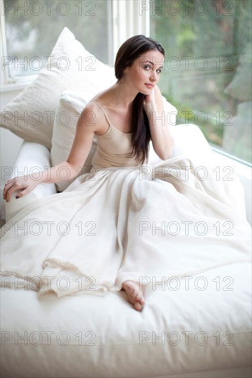 Glamorous Caucasian woman sitting on sofa