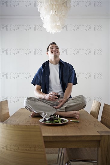 Caucasian man having dinner sitting on table