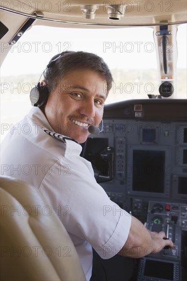 Hispanic pilot in cockpit