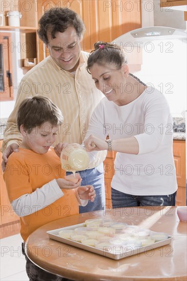 Hispanic family making cupcakes