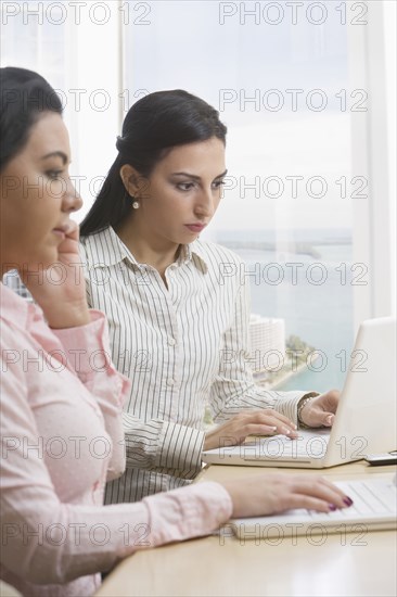 Businesswomen using laptops
