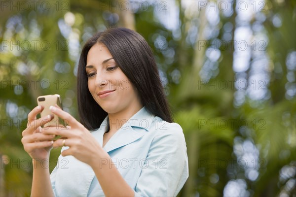 Turkish woman text messaging on cell phone