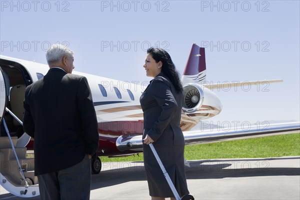 Business people boarding private jet