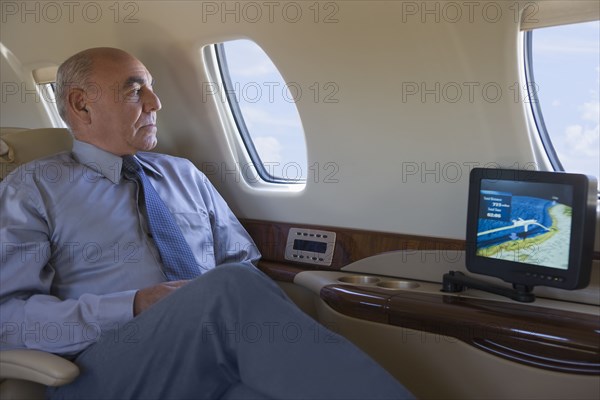 Hispanic businessman on private jet